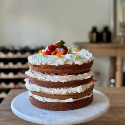 Four layer strawberry cake with mascarpone whip