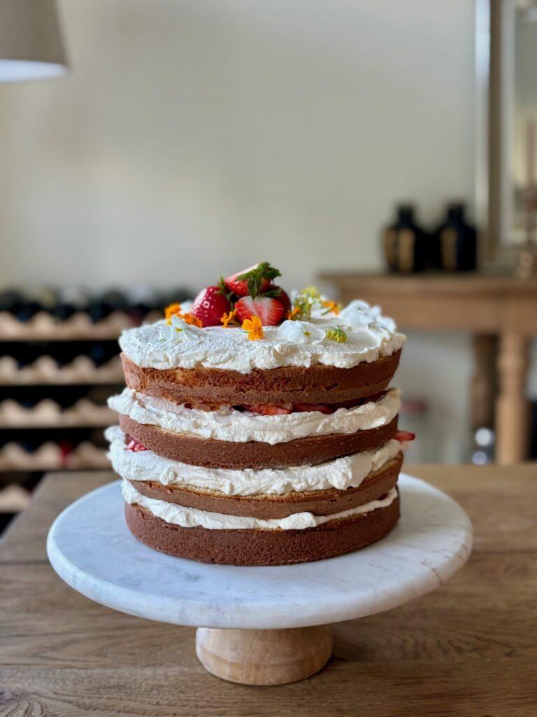 Four layer strawberry cake with mascarpone whip
